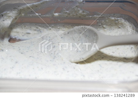 Creamy Herb Sauce Being Stirred with a Spoon 138241289