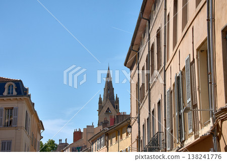 Gothic church tower rising among historic buildings in Aix-en-Provence under a clear blue sky in France 138241776