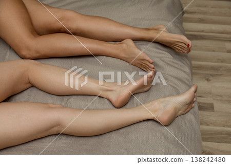 close up of a female legs in a bed close up of a female legs in a bed 138242480