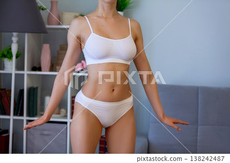 young adult woman in white bikini at home young adult woman in white bikini at home 138242487