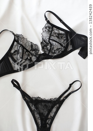 Black lacy sexy lingerie over white. Shopping and fashion concept. glamorous stylish sexy lace lingerie, woman accessories on white background. Top view point, flat lay. Black lacy sexy lingerie over white. Shopping and fashion concept. glamorous stylish sexy lace lingerie, woman accessories on white background. Top view point, flat lay. 138242489