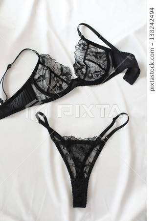 Black lacy sexy lingerie over white. Shopping and fashion concept. glamorous stylish sexy lace lingerie, woman accessories on white background. Top view point, flat lay. Black lacy sexy lingerie over white. Shopping and fashion concept. glamorous stylish sexy lace lingerie, woman accessories on white background. Top view point, flat lay. 138242494