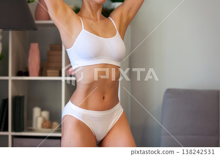 young adult woman in white underwear at home young adult woman in white underwear at home 138242531