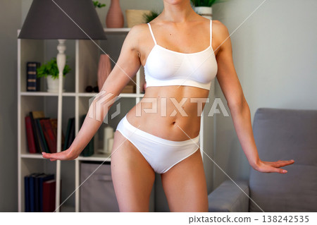young adult woman in white bikini at home young adult woman in white bikini at home 138242535