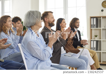 Group of happy joyful smiling business people applaudding to speaker sitting in a meeting room. Group of happy joyful smiling business people applaudding to speaker sitting in a meeting room. 138242537