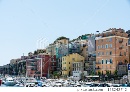 A pastel-colored building with blackout doors bathed in bright sunlight on the French island of Corsica in the Mediterranean Sea. A pastel-colored building with blackout doors bathed in bright sunlight on the French island of Corsica in the Mediterranean Sea. 138242742
