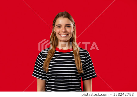 Portrait of Kind Smiling Blonde woman With Natural Hair on Red,Joyful Expression 138242798