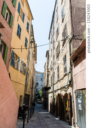 Pastel-colored buildings and alleyways under the bright sunlight on the French island of Corsica in the Mediterranean Sea. 138243003
