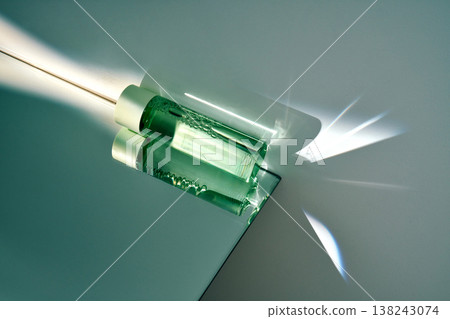 Cosmetic serum glass bottle creating light refractions 138243074
