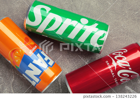 Mykolaiv, Ukraine - March 25, 2026: Iron cans of Coca Cola, Fanta and Sprite drink on grey concrete background. Mykolaiv, Ukraine - March 25, 2026: Iron cans of Coca Cola, Fanta and Sprite drink on grey concrete background. 138243226