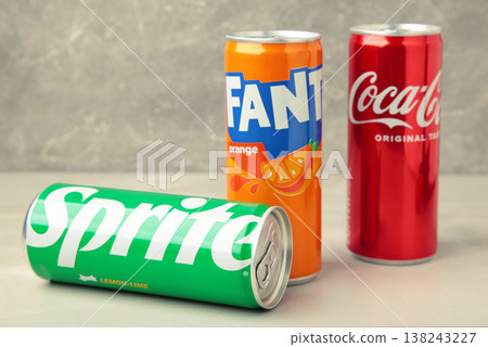 Mykolaiv, Ukraine - March 25, 2026: Iron cans of Coca Cola, Fanta and Sprite drink on light background. Mykolaiv, Ukraine - March 25, 2026: Iron cans of Coca Cola, Fanta and Sprite drink on light background. 138243227