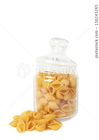 Conchiglie rigate. Raw striped shell pasta in jar isolated on white background Conchiglie rigate. Raw striped shell pasta in jar isolated on white background 138243265