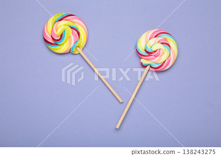 Colorful lollipops on purple background. Space for text 138243275