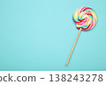 Colorful lollipop on blue background. Space for text 138243278