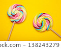 Colorful lollipops on yellow background. Space for text 138243279