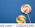 Colorful lollipops on dark blue background. Space for text 138243280