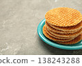 Stack of Dutch stroopwafel cookies or caramel waffles on plate on grey concrete background. Space for text 138243288