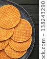 Dutch waffles stroopwafel syrup waffle caramel waffle on plate on black background. Vertical photo 138243290