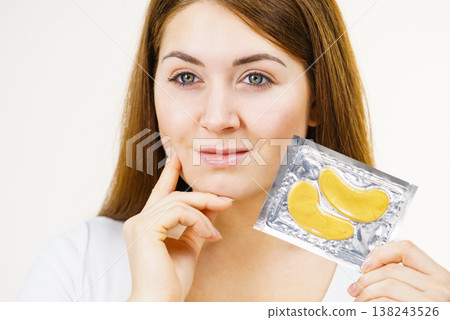 Woman ready to apply gold eye patches 138243526