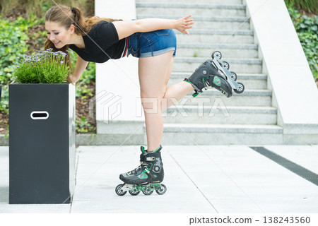 Young woman riding roller skates Young woman riding roller skates 138243560