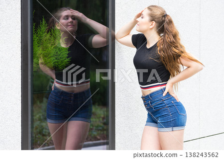 Fashionable teen presenting summer outfit Fashionable teen presenting summer outfit 138243562