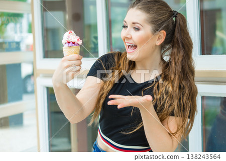 Young woman eating ice cream Young woman eating ice cream 138243564