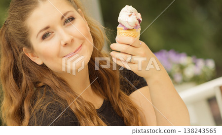 Young woman eating ice cream Young woman eating ice cream 138243565