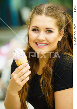 Young woman eating ice cream Young woman eating ice cream 138243568