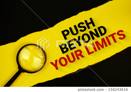 Push Beyond Your Limits text on yellow with black paper torn ripped and magnifying glass 138243616