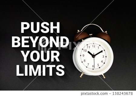 Push Beyond Your Limits text with alarm clock on black background 138243678
