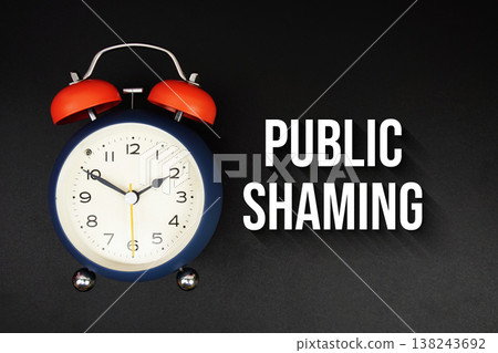 Public Shaming text with alarm clock on black background 138243692