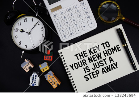 Notepad with the phrase "The Key To Your New Home Is Just A Step Away" surrounded by a pen, calculator, magnifying glass, clock, and house model Notepad with the phrase "The Key To Your New Home Is Just A Step Away" surrounded by a pen, calculator, magnifying glass, clock, and house model 138243694