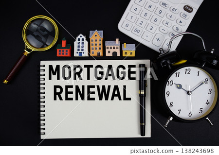Notepad with the phrase "Mortgage Renewal" surrounded by a pen, calculator, magnifying glass, clock, and house model Notepad with the phrase "Mortgage Renewal" surrounded by a pen, calculator, magnifying glass, clock, and house model 138243698