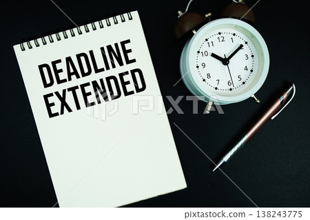 Deadline Extended text written on notepad with pen and alarm clock Deadline Extended text written on notepad with pen and alarm clock 138243775