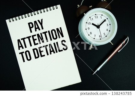 Pay Attention To Details text written on notepad with pen and alarm clock 138243785