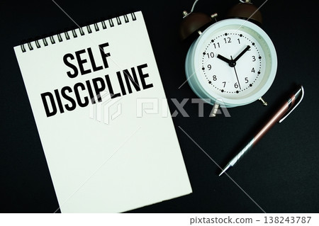 Self Discipline text written on notepad with pen and alarm clock Self Discipline text written on notepad with pen and alarm clock 138243787