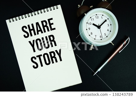 Share Your Story text written on notepad with pen and alarm clock Share Your Story text written on notepad with pen and alarm clock 138243789
