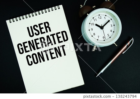 User Generated Content text written on notepad with pen and alarm clock User Generated Content text written on notepad with pen and alarm clock 138243794