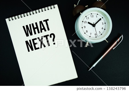 What Next? text written on notepad with pen and alarm clock What Next? text written on notepad with pen and alarm clock 138243796