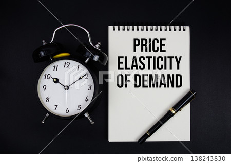 Price Elasticity of Demand (PED) text written on notepad with alarm clock top view on black background Price Elasticity of Demand (PED) text written on notepad with alarm clock top view on black background 138243830