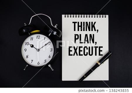 Think, Plan, Execute text written on notepad with alarm clock top view on black background Think, Plan, Execute text written on notepad with alarm clock top view on black background 138243835