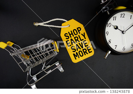 Mini Trolley Shopping Cart and price tag with message "Shop Early, Save More" and alarm clock on black background Mini Trolley Shopping Cart and price tag with message "Shop Early, Save More" and alarm clock on black background 138243878
