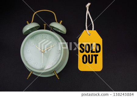 Price tag with message "Sold Out" and alarm clock on black background Price tag with message "Sold Out" and alarm clock on black background 138243884