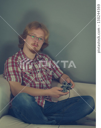 Gamer man playing using gaming pad Gamer man playing using gaming pad 138244369