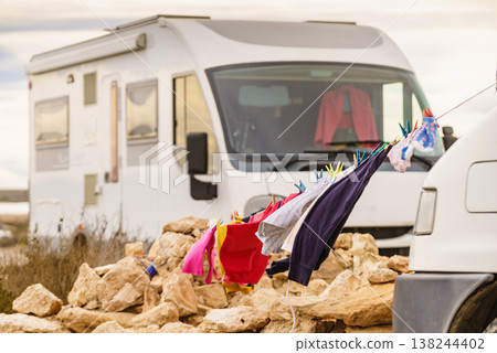 Washing laundry hanging to dry outdoors at caravan. Camping on nature, lifestyle. Washing laundry hanging to dry outdoors at caravan. Camping on nature, lifestyle. 138244402