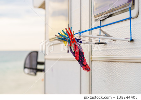 Camping on the sea. Clothes hanging to dry by camper rv. Camping on the sea. Clothes hanging to dry by camper rv. 138244403