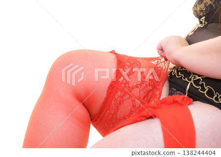 Woman plus size puts on red nylon stockings 138244404