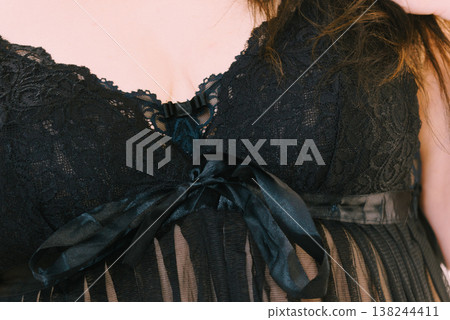 Woman in black lingerie showing her breast chest. 138244411