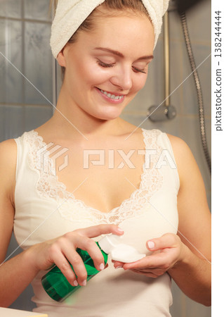 Woman with cotton swab cleaning her skin. Woman with cotton swab cleaning her skin. 138244444