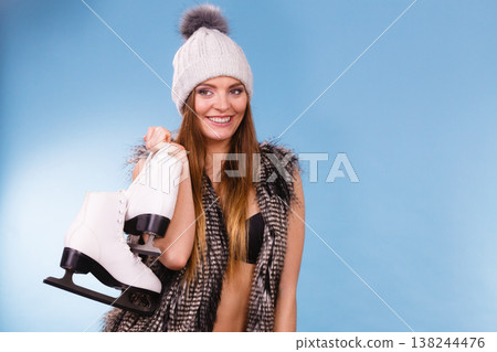 Woman holding ice skates, winter sport 138244476